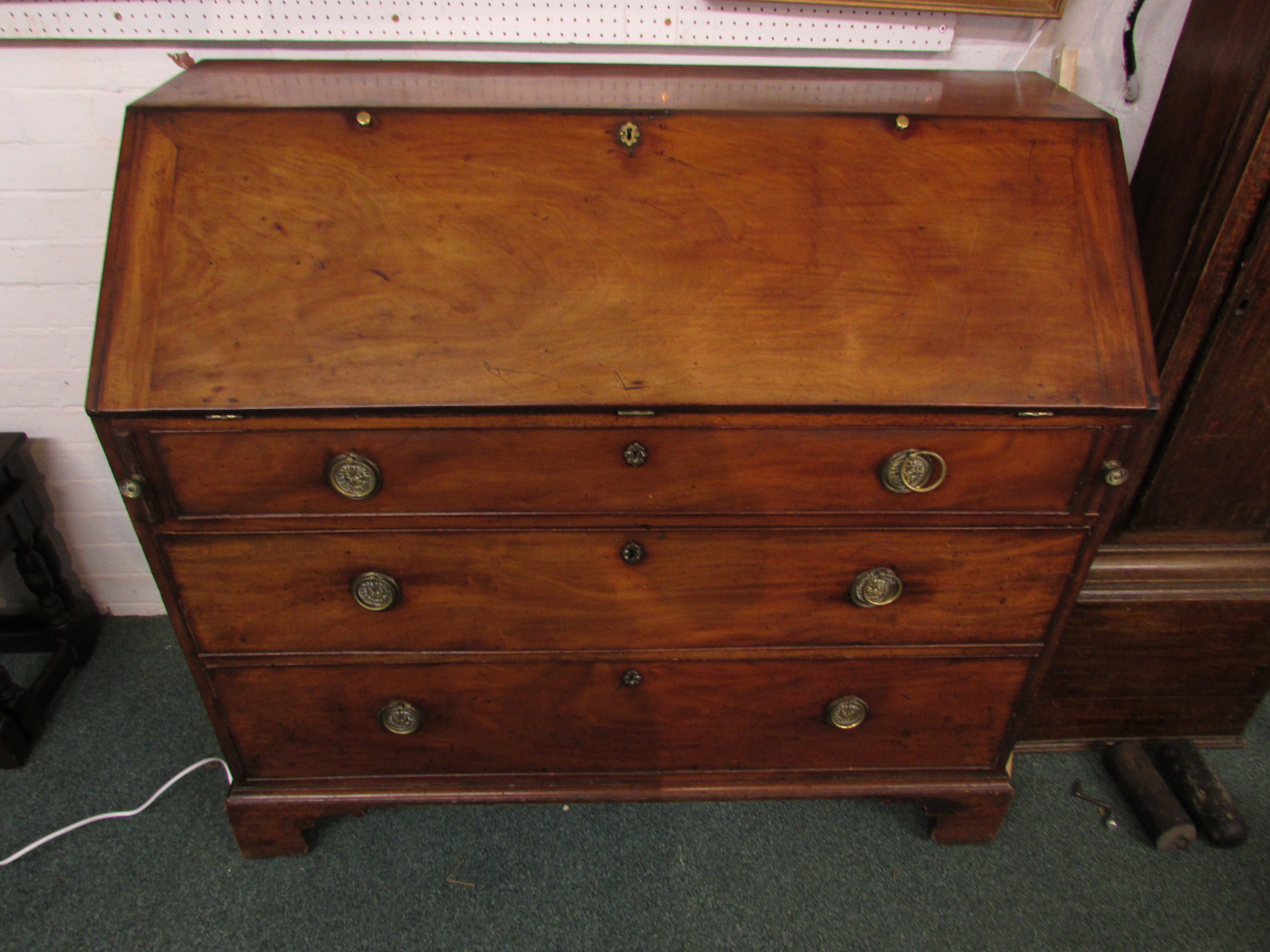 A 19th century large and wide mahogany bureau, the interior with a line of five small drawers over a