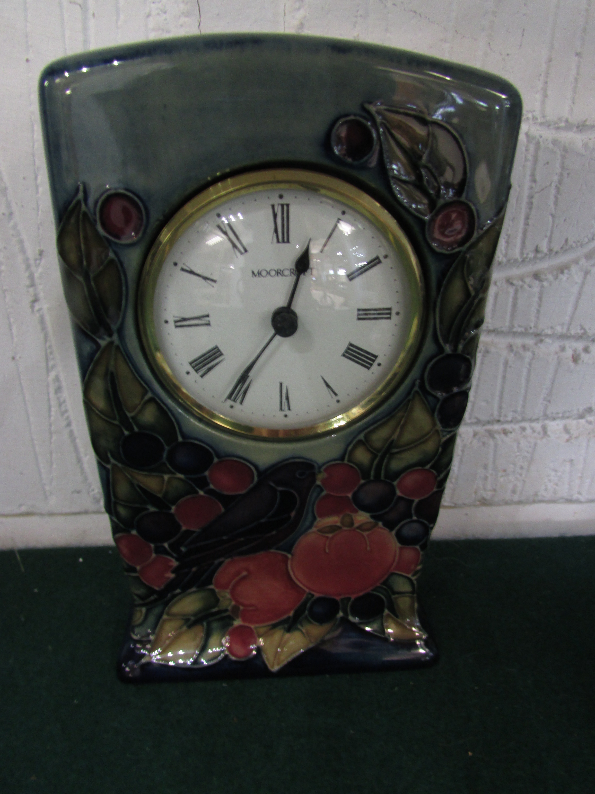 Moorcroft pottery mantel clock, blue graduating to green with fruits and bird, height 15.5cm,