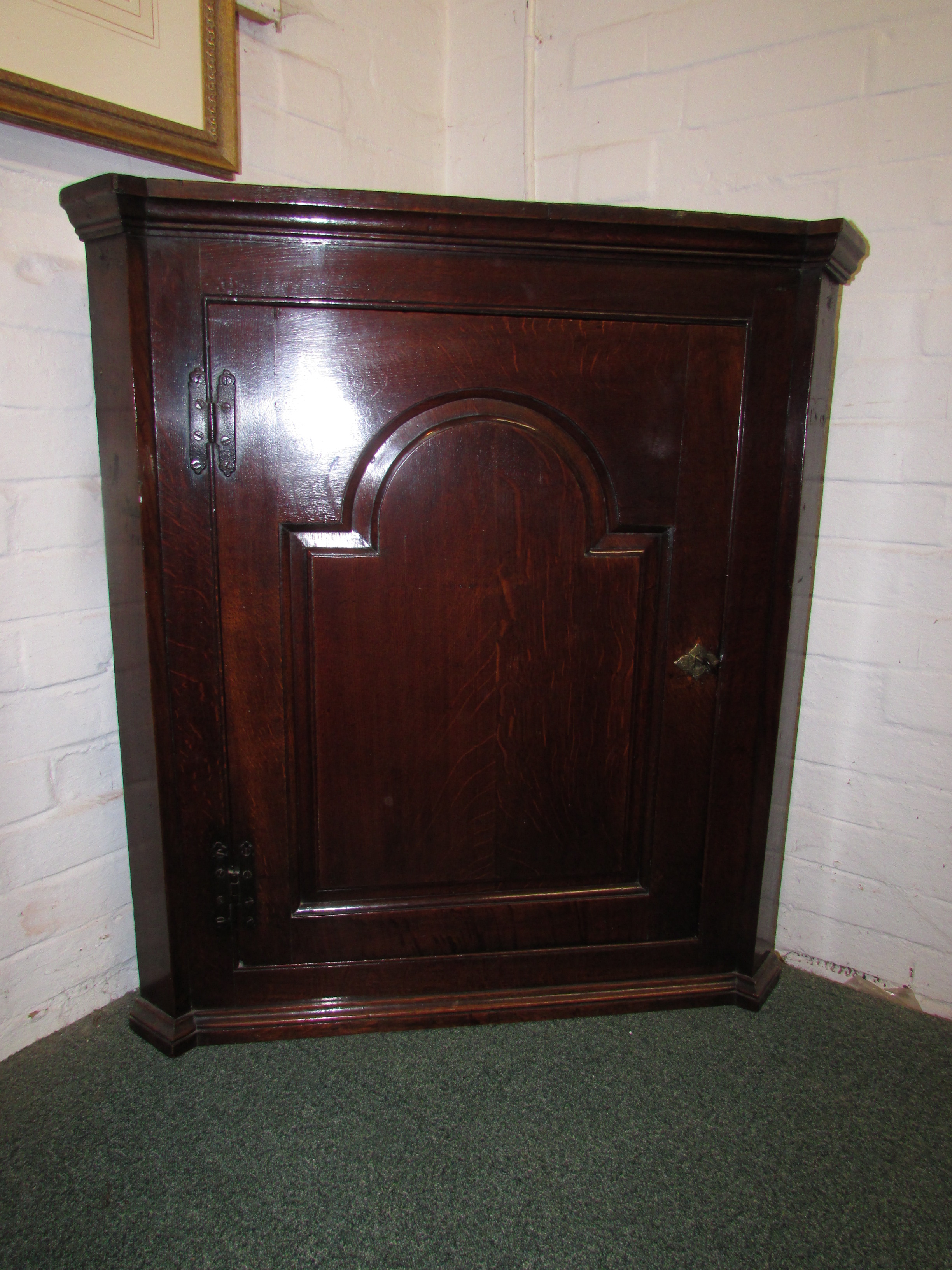 George III oak corner cabinet, the single door with arched moulding and on iron H hinges, engraved