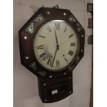 A Victorian eight-day striking wall clock. The octagonal case is of rosewood veneer and inlaid