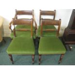 Four 19th century mahogany dining chairs (including one carver) with green upholstered seats and