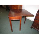 A Pembroke type rectangular folding tea table in mahogany, a concealed drawer to one end, standing