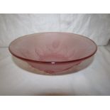 A frosted pink glass bowl in the style of Etling and moulded with pine cones (diameter 21.5cm),