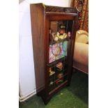 NARROW OAK BOOKCASE WITH GLAZED AND LEADED DOOR WITH CONVEX PANELS AND BAKELITE HANDLE