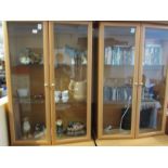 TWO LIGHT WOOD EFFECT ILLUMINATED LOUNGE DISPLAY CABINETS WITH TWO DOOR CUPBOARD TO BASES, AND