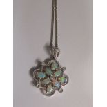 PENDANT STAMPED 14K SET WITH EIGHT OPALESCENT STONES IN A FOLIATE SETTING WITH FIVE WHITE STONES