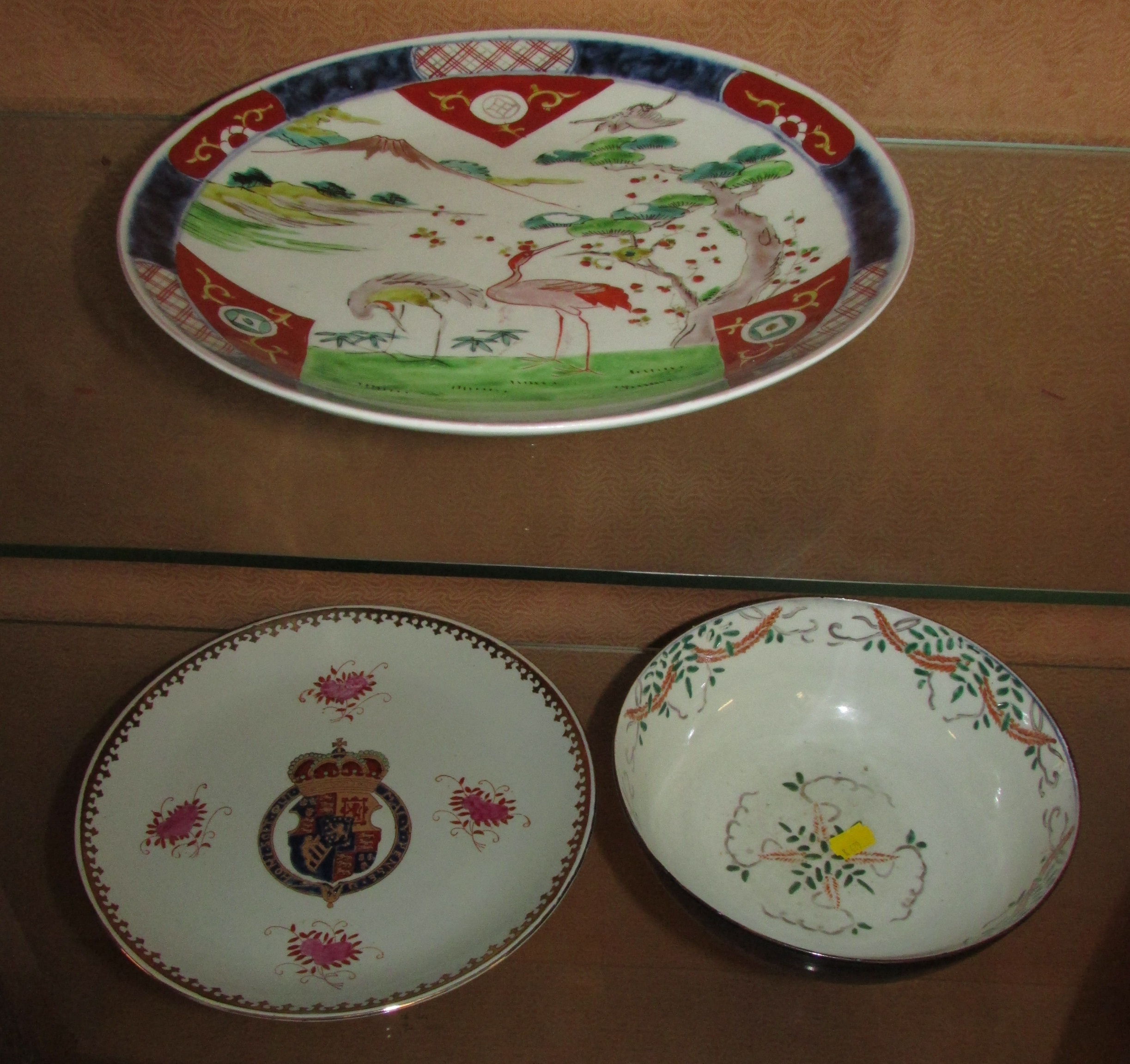 JAPANESE STYLE PLATE ENAMELLED WITH CRANES AND MOUNTAIN, A PLATE WITH ARMORIAL ENAMELLING, AND A