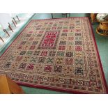 CARPET TRADES LTD OF KIDDERMINSTER AMBALA RED GROUND FLOOR RUG PATTERNED WITH SQUARE EMBLEMS