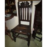 CARVED DARK OAK SIDE CHAIR WITH PLANK SEAT