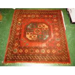 MIDDLE EASTERN STYLE RED GROUND CARPET WITH SINGLE MEDALLION AND MARGINS OF STYLIZED FLOWERS