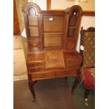 A 1920's mahogany ladies bonheur du jour standing on cabriole legs. The writing section with a small