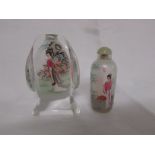 A Chinese scent or snuff glass bottle interior painted with two female figures and bamboo with a