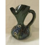 Elton ware (Clevedon) pottery jug, green glaze with slip decoration of twig and berries, height