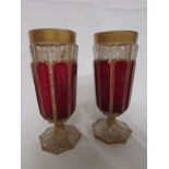 A matched pair of 19th century ruby red and gilt champagne flutes, height 15.5cm