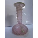 A Roman style glass vase, pink with opalescence in places, low squat body with flaring neck, the