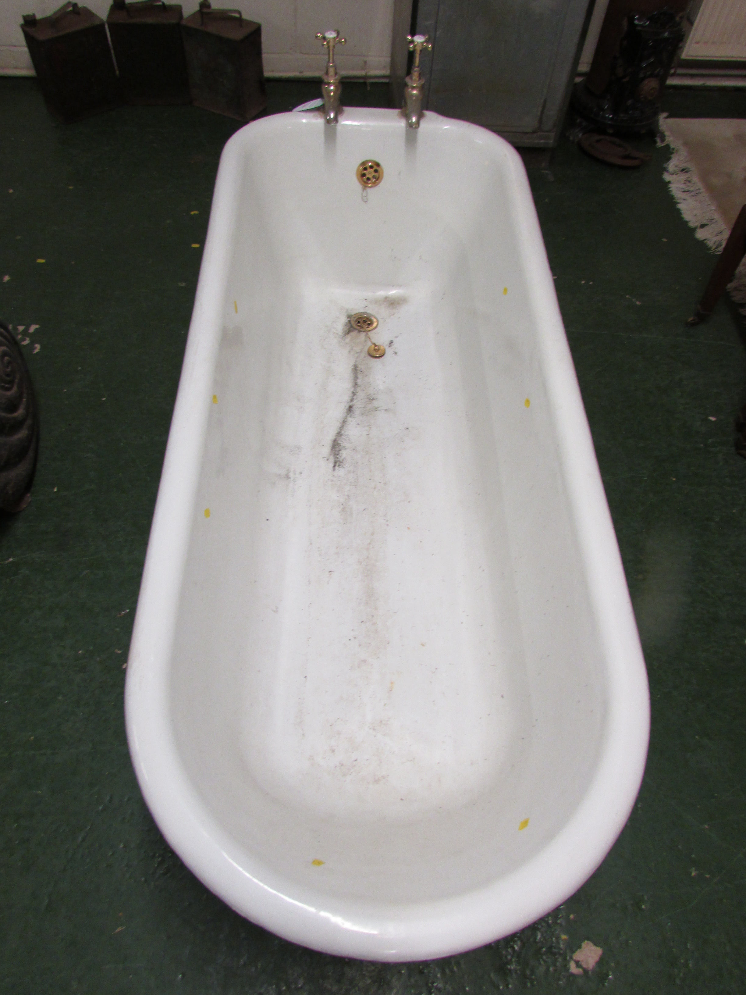 Cast iron enamel bath, white to the interior, black to the exterior, raised on four feet and