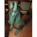 Carved wood and polychrome painted figure of a seated horse (height 61cm, length 68cm)