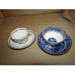 Caughley blue and white tea bowl and saucer in early willow pattern with gilt trim, the base of