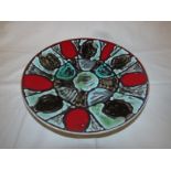 Poole plate by Angela Wyburgh, abstract pattern in green, brown and red, diameter 27cm, the base