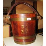 OAK BUCKET WITH BRASS BANDING, LEATHER CLAD ROPE HANDLE AND REMAINS OF TRANSFER DECORATED COAT OF