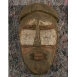 A Southern Congolese carved wooden mask with Kaolin decoration. 40cm high