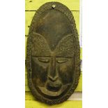 An African wall mask made using some composite stone or clay 40cm high