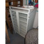 caged shelf unit with lockable (lift off) doors on wheels. 65 x 65 x 120 high