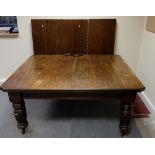 Edwardian oak extending wind out dinning table, with three extra leaves,