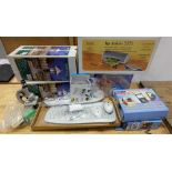 A mixed collection of boxed items to include Die cast garden lanterns, footspa, Prinz microscope,