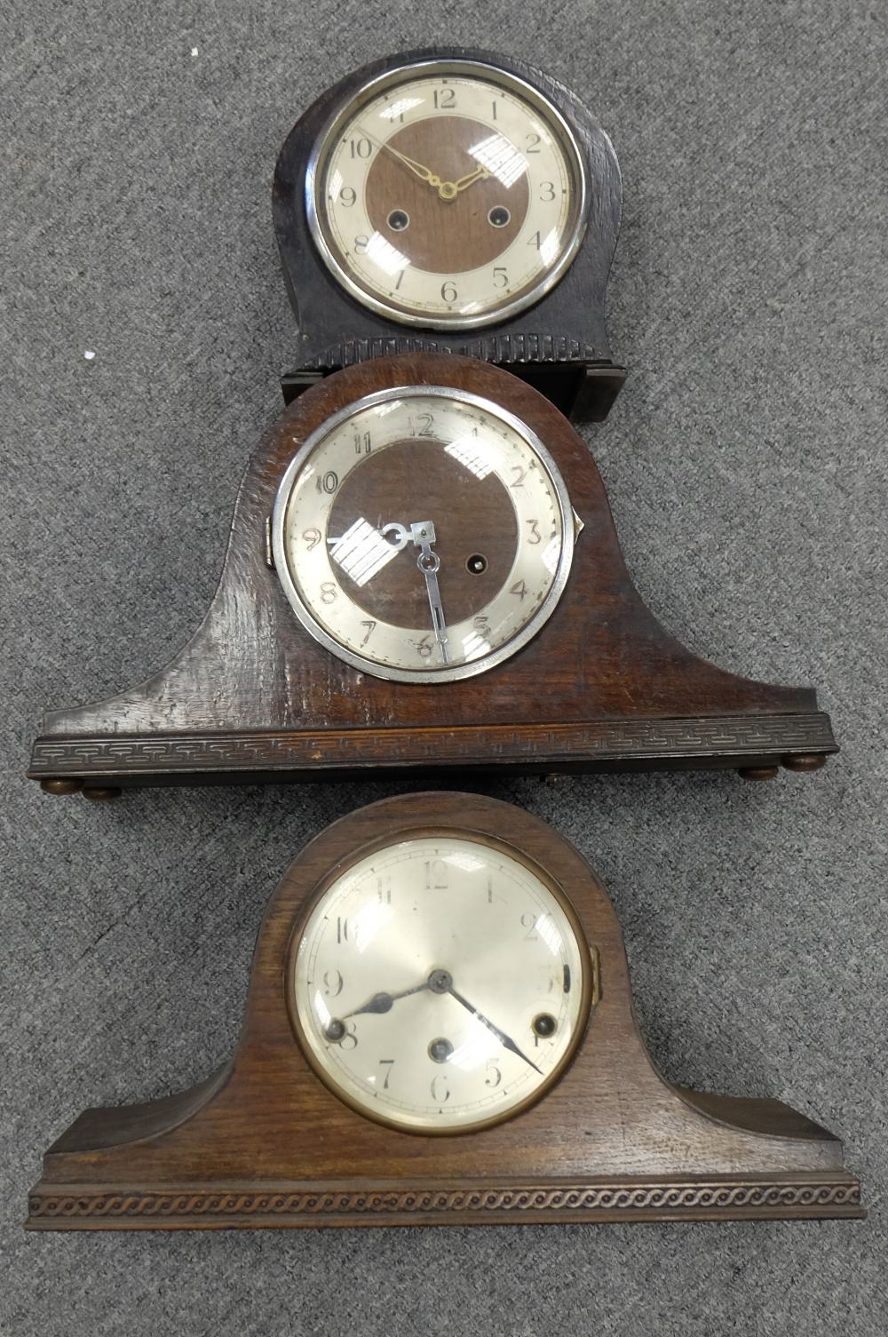 A collection of three oak cased mantle clocks