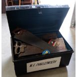 Large tin travel trunk with a collection of hand tools held within to include saws, planes, clamps,