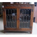 Reproduction carved oak bookcase with leaded glass doors