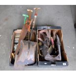 A collection of vintage hand tools and gardening equipment