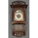 Oak Cased wall clock with oriental influenced face