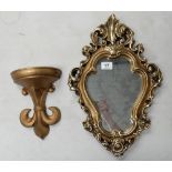 Stylized wall mirror and fleur de ley shaped wall shelf (2)