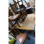 Oak drawer leaf extending table and four matching chairs.