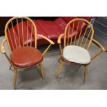 A pair of Ercol Windsor elm carvers.