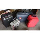 A collection of four mixed sized fabric suitcases.