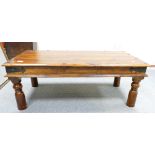 Reproduction teak wood coffee table with metal studs.