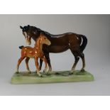 Beswick brown mare and chestnut foal on base,