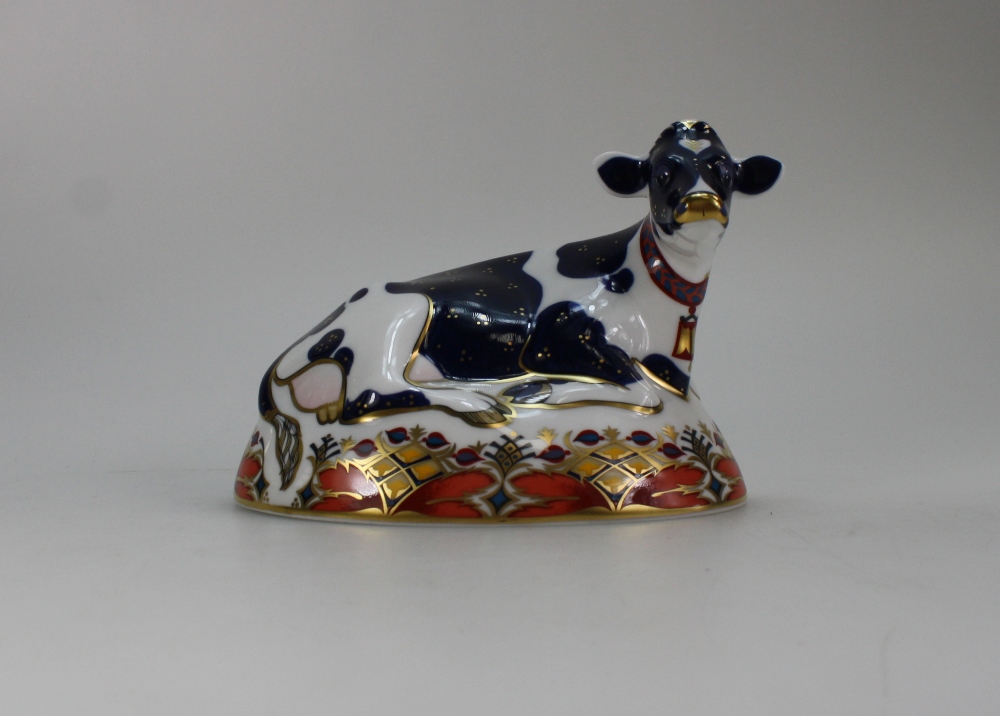 Royal Crown Derby paperweight of Friesian Cow with gold stopper,