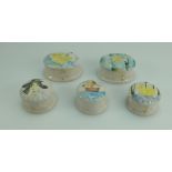 A collection of Lise B Moorcroft art pottery round & oval small boxes & covers tube lined decorated