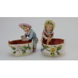 Pair early 20th Century small porcelain spill vases modelled as girl with dolly and boy with toy