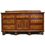 Late Georgian Mahogany oak dresser base having 7 drawers with 2 centre cupboard doors 188cm x 56cm