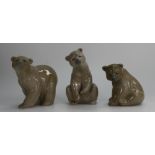 A collection of Lladro brown bears, two seated and one walking,