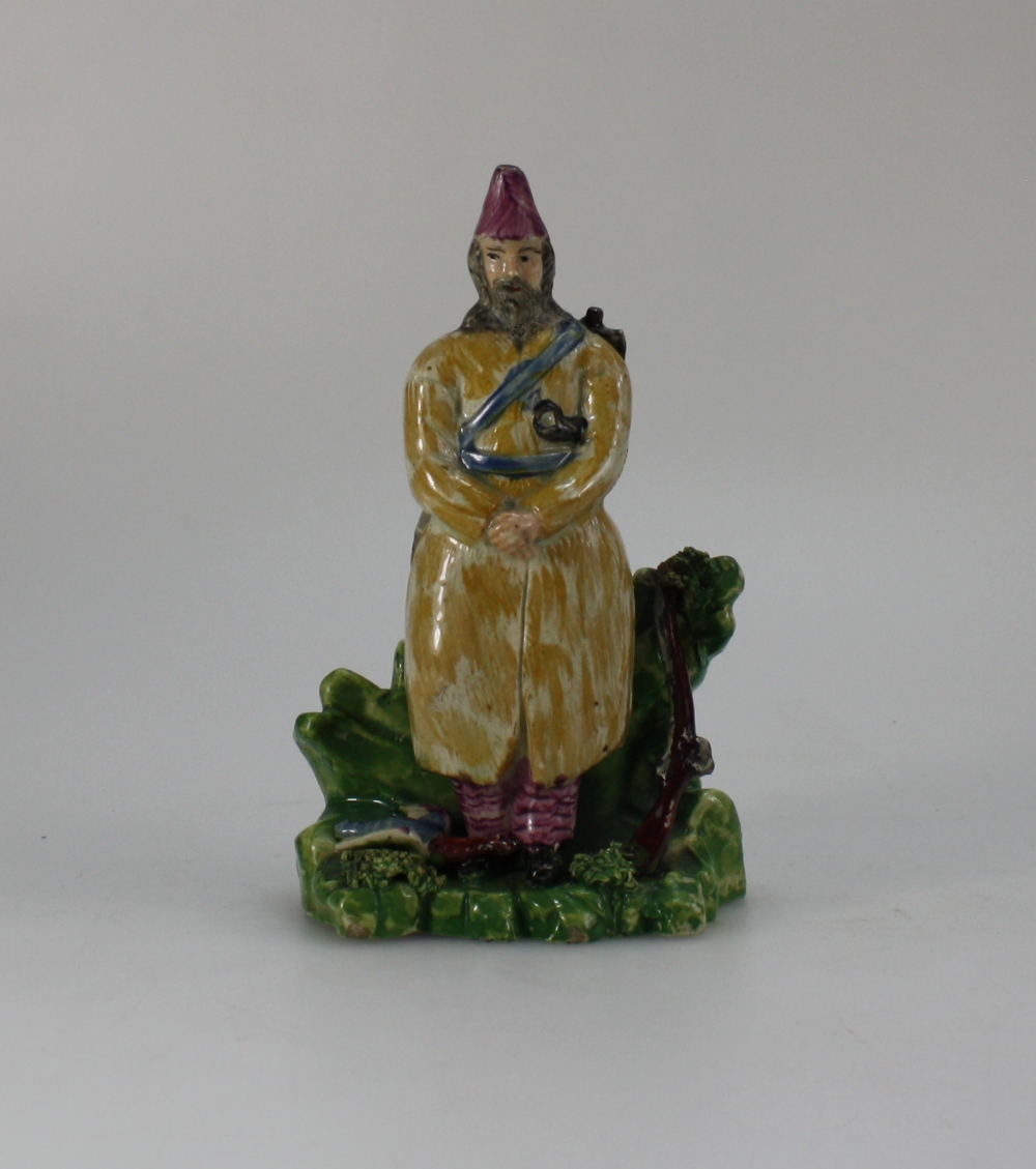 19th Century Staffordshire figure of man standing with gun & duck, height 16.