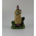 19th Century Staffordshire figure of man standing with gun & duck, height 16.