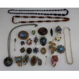 A collection of good vintage costume jewellery to include Amber necklace, brooches,