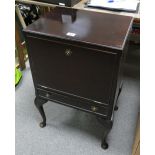 Burr walnut cabinet on Queen Anne legs, with fold out doored compartment above slim drawer.