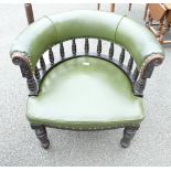 Green leather Captains arm chair with floral carving.